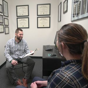 Dr. Nick Lee giving patient evaluation at Enlighten Chiropractic in Lakeville MN