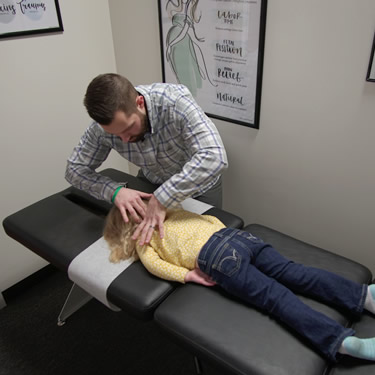 dr-nick-adjusting-child-on-table