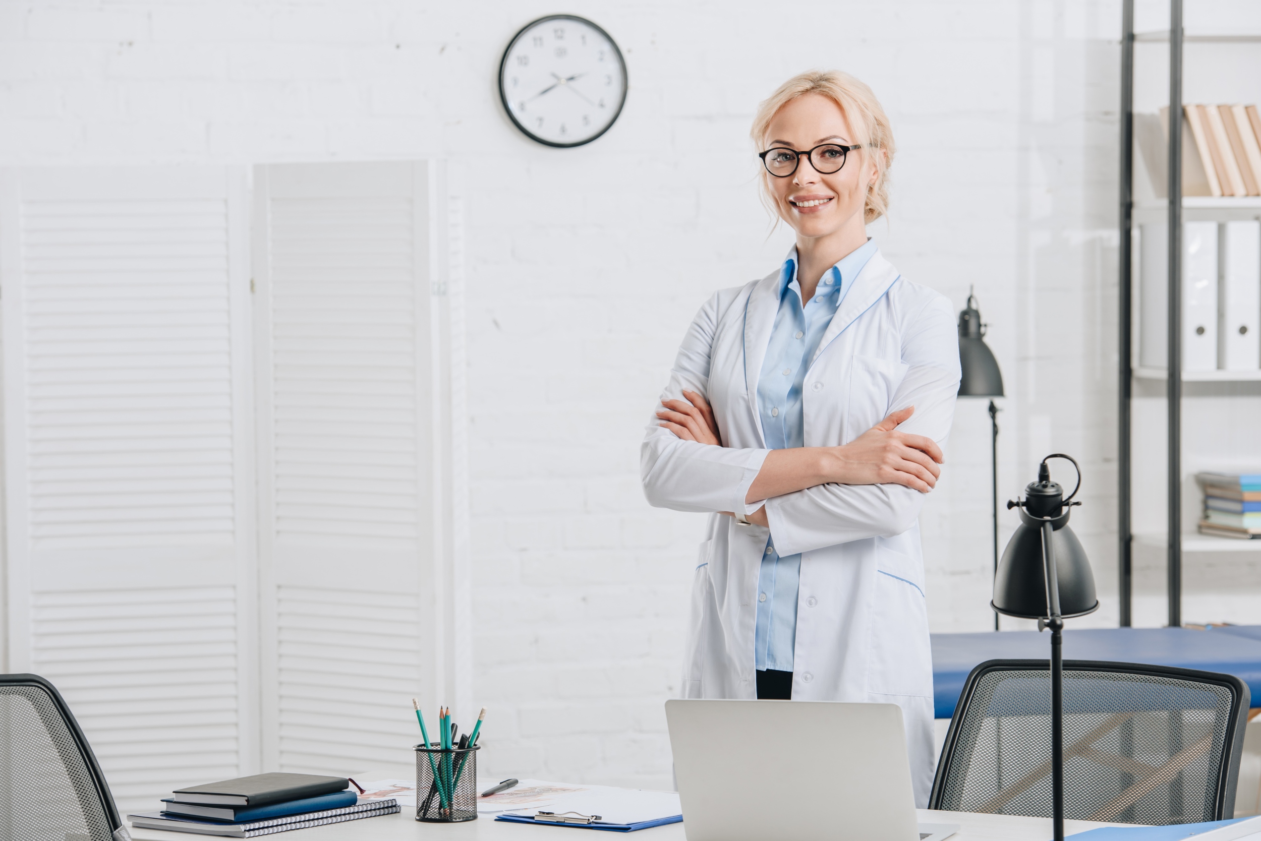 portrait-of-smiling-chiropractor-in-eyeglasses-and-SA2D6V6