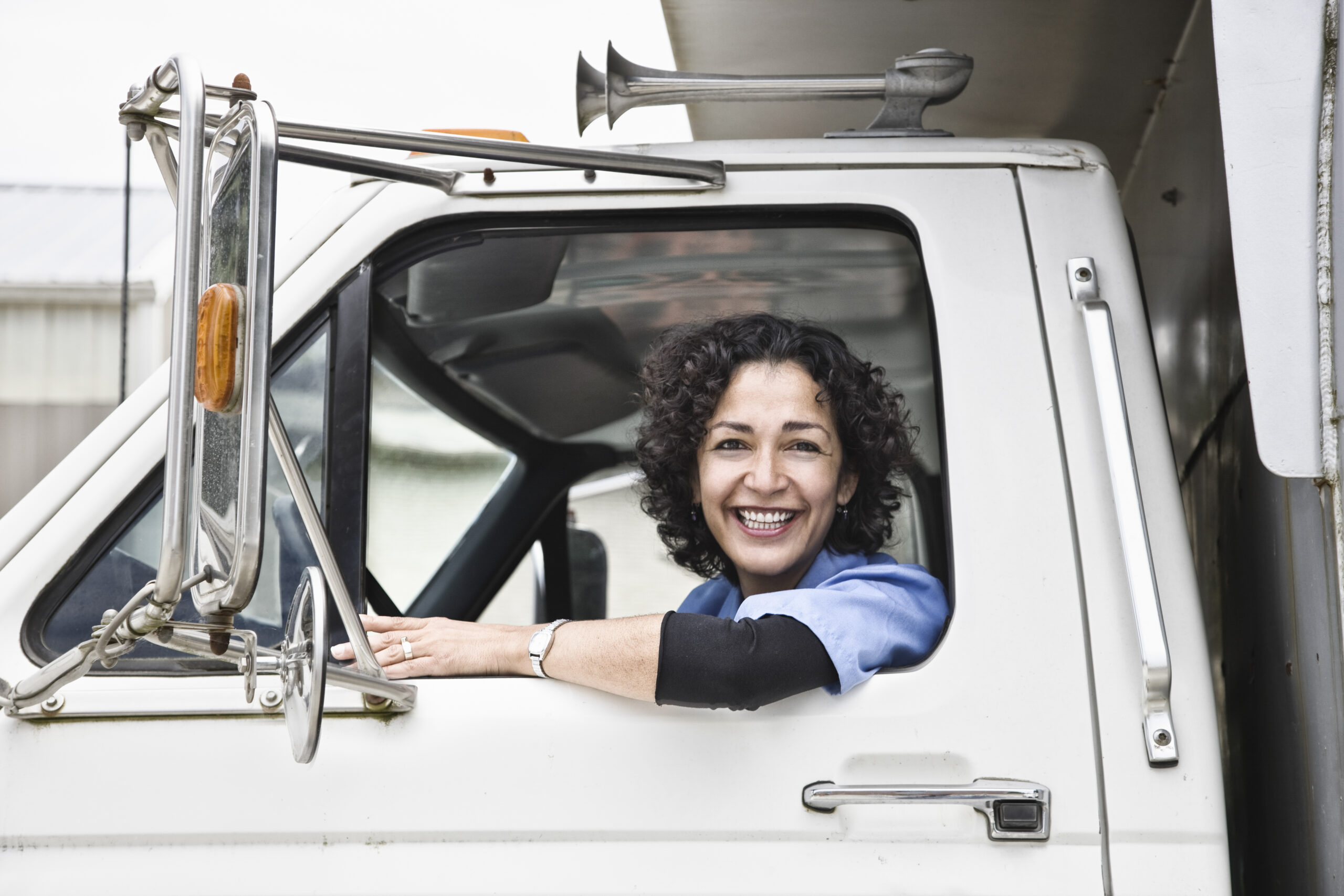 https://enlightenlakeville.com/wp-content/uploads/2021/05/hispanic-woman-truck-driver-scaled.jpg