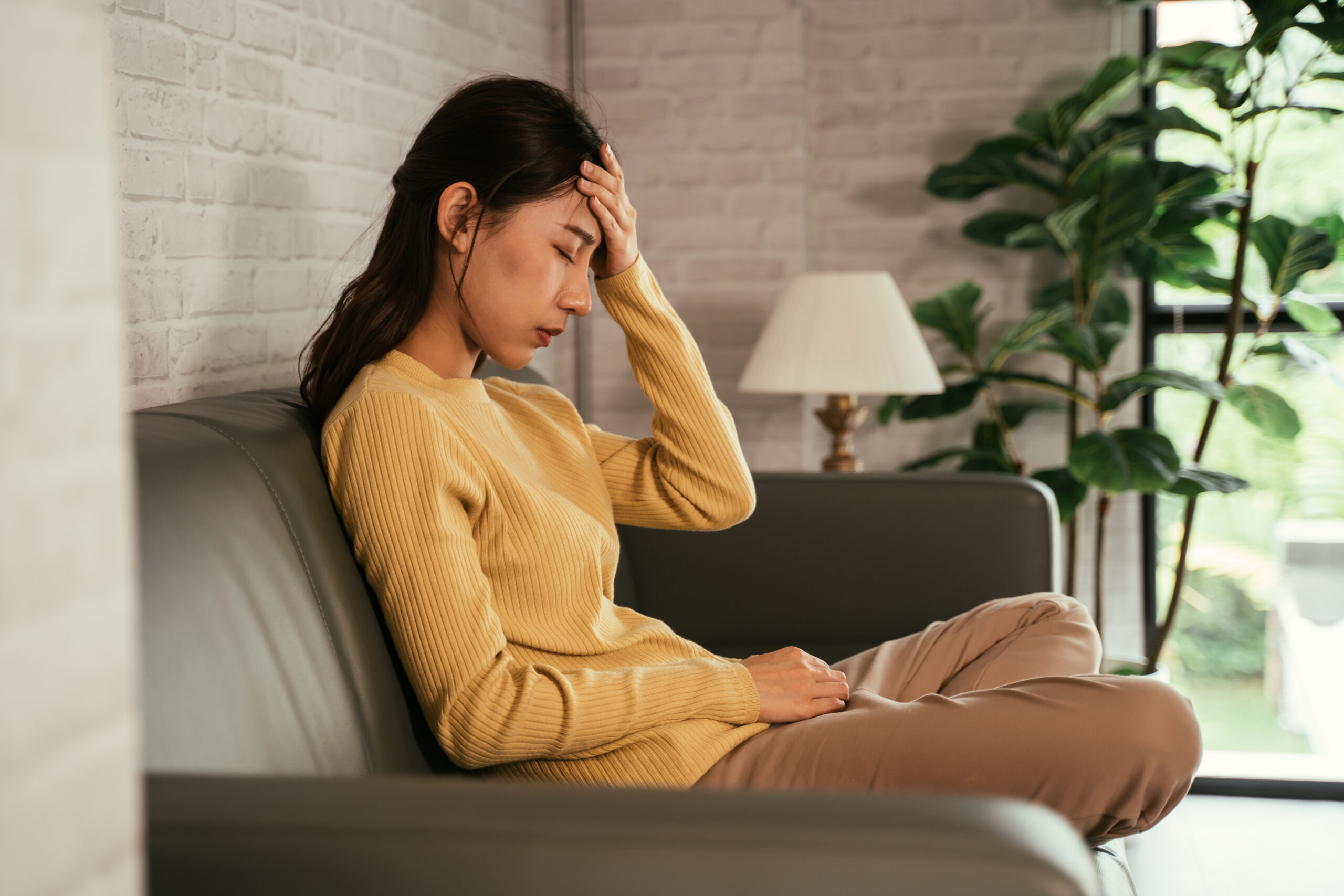 Woman at home suffering from headache